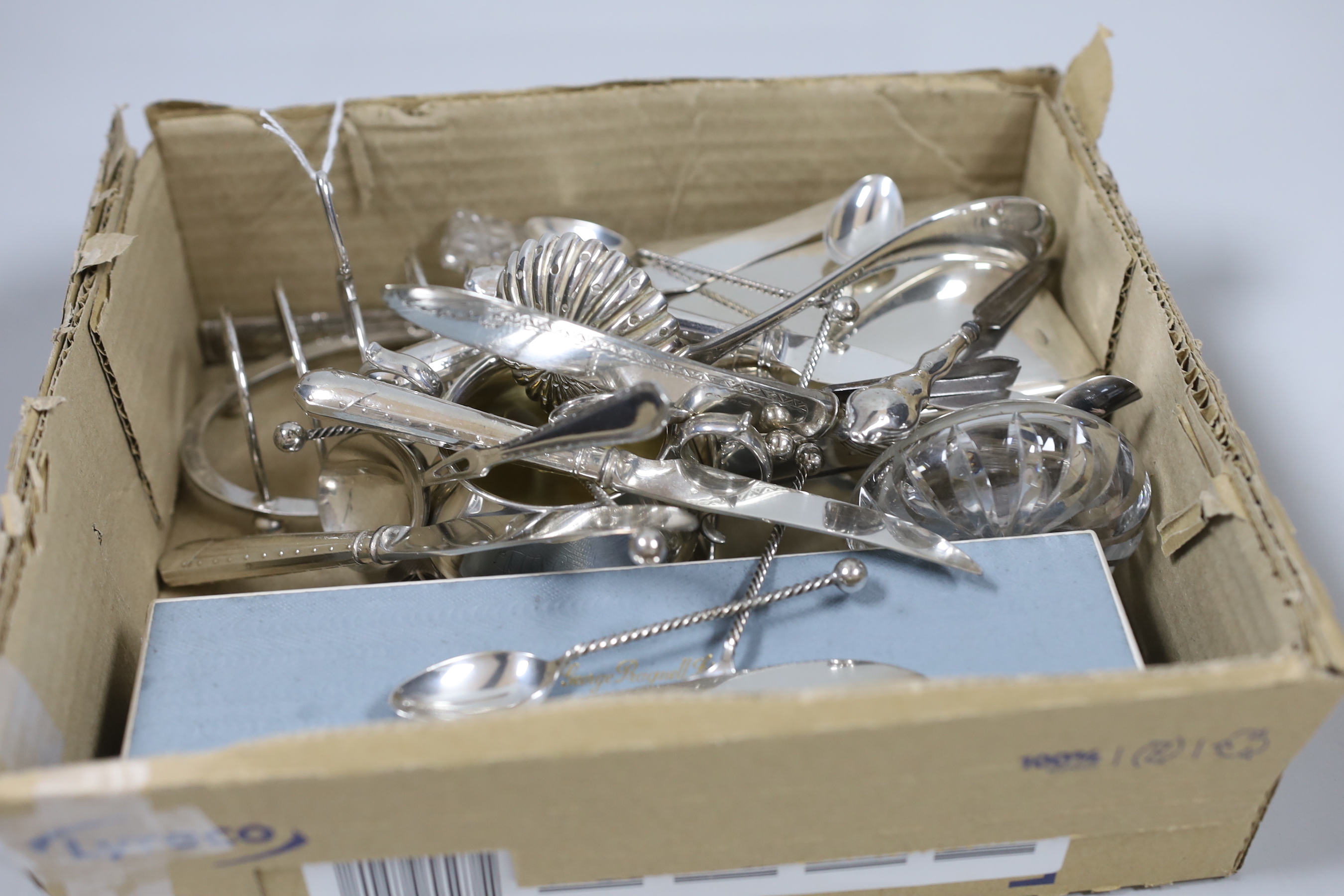 A small group of sundry small silver including a set of four napkin rings, cigarette box, sugar bowl, toastrack, scent bottle, 19th century white metal needle case, Egyptian white metal dishes and assorted flatware inclu